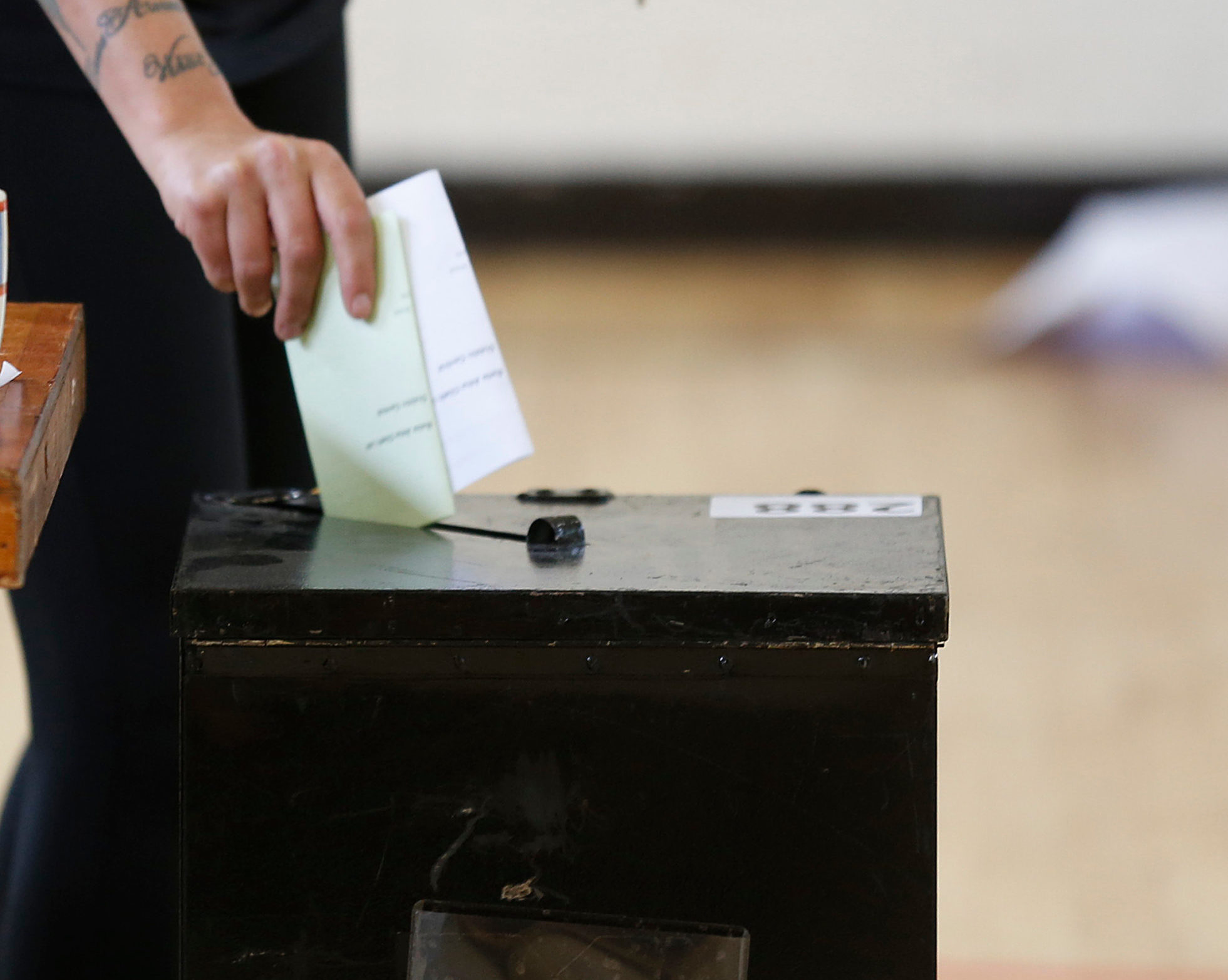 Decorative image of vote being placed into a ballot box