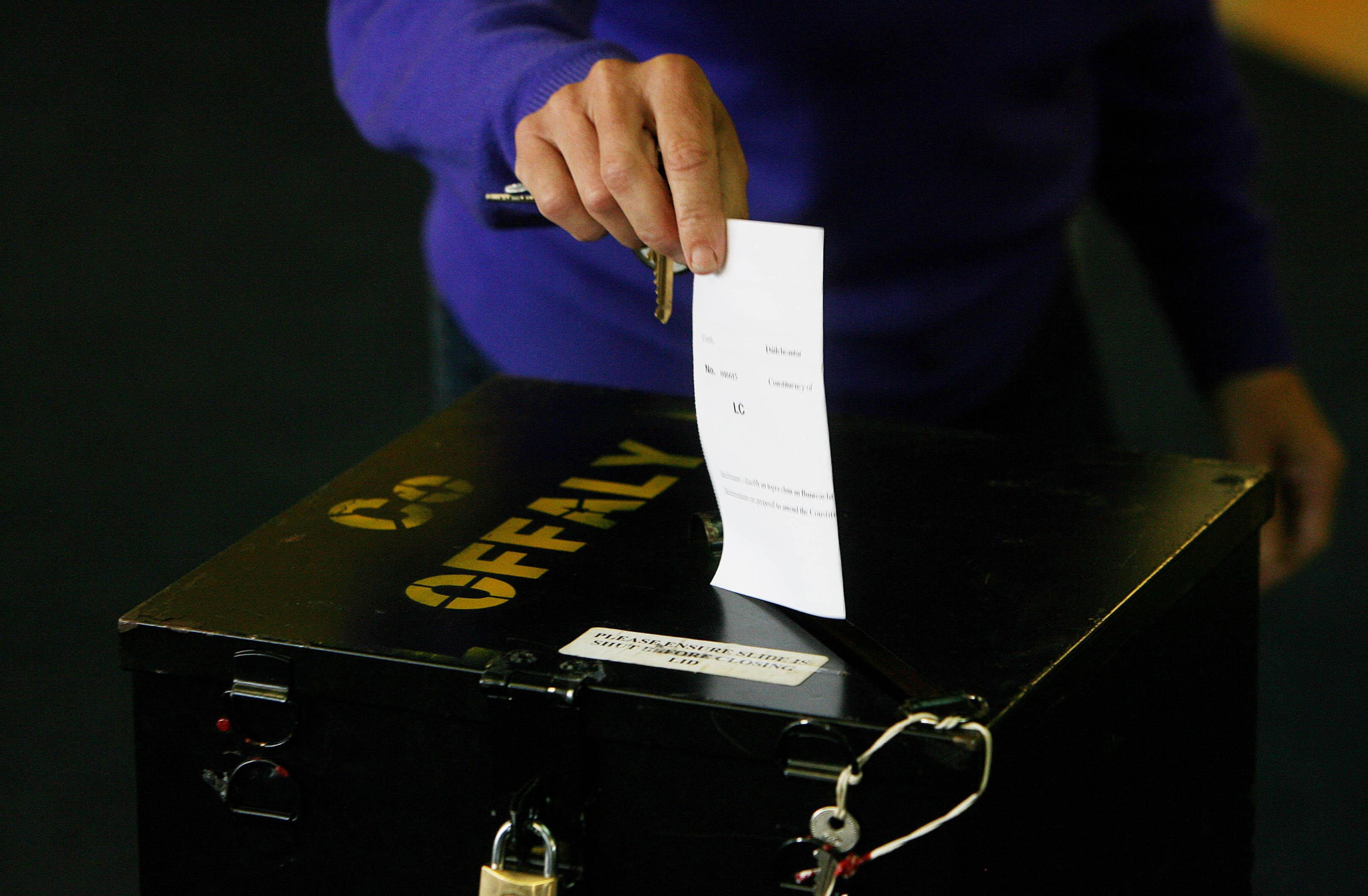Vote being placed into a ballot box