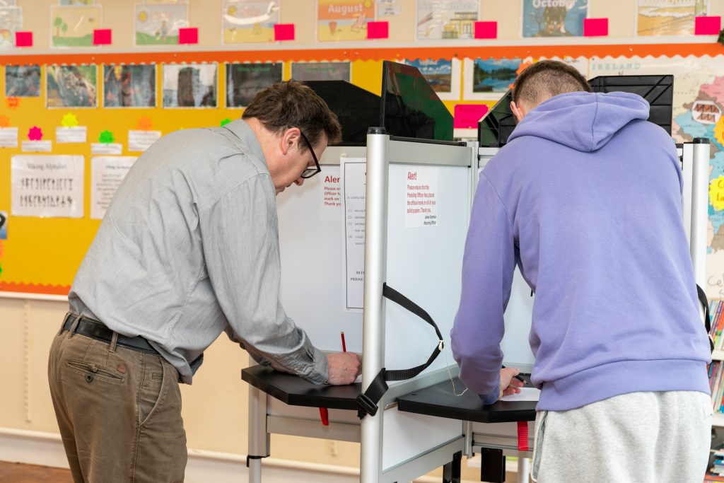 Image of voters marking their ballot