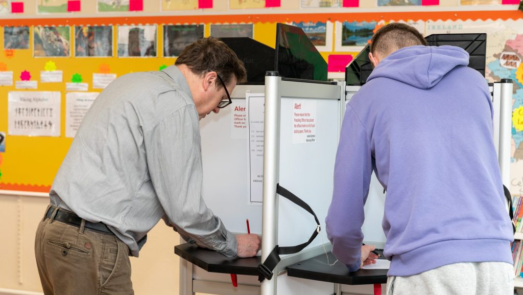 Image of voters marking their ballot