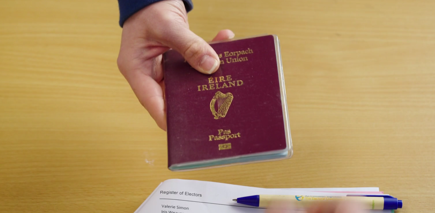 Image of ID being handed to polling staff.