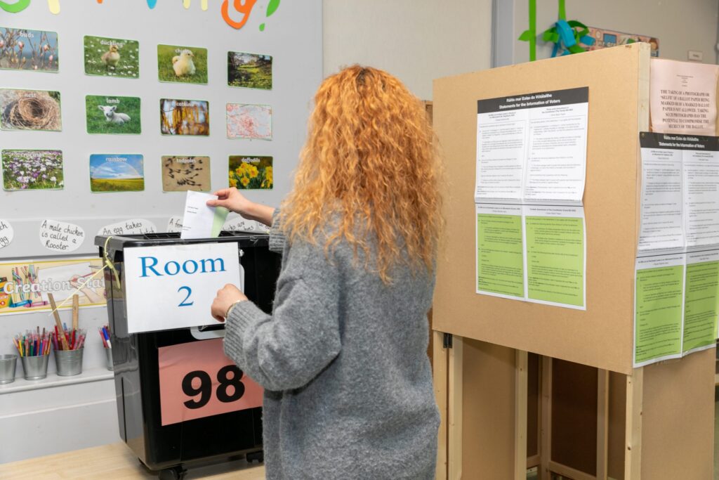 Picture of woman placing her vote into the ballot box